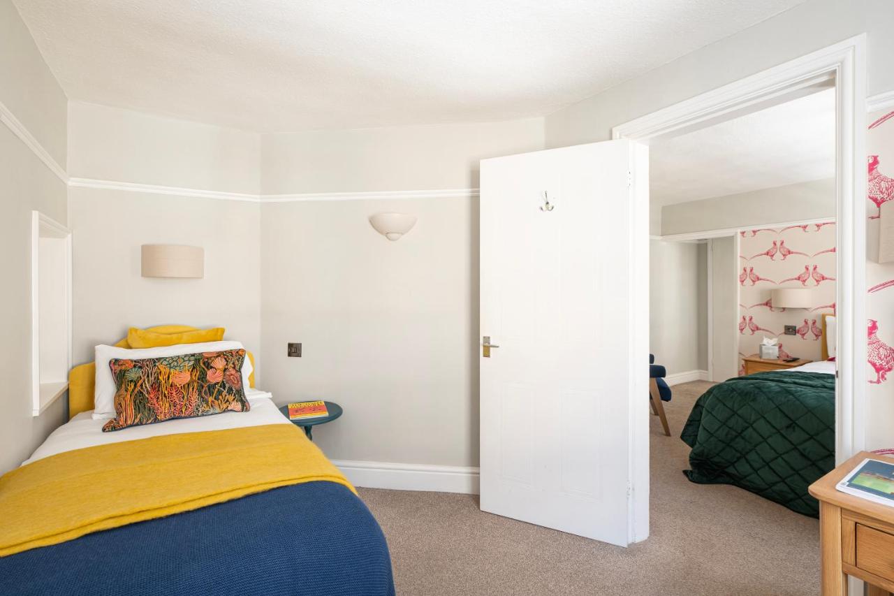 a bedroom with a bed and a sliding door at Harington's Boutique Hotel in Bath